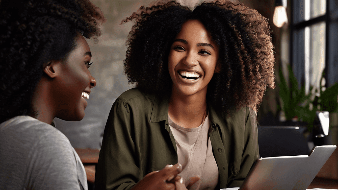 Two women laughing and interacting, suggesting collaboration and a supportive atmosphere for those seeking contact.